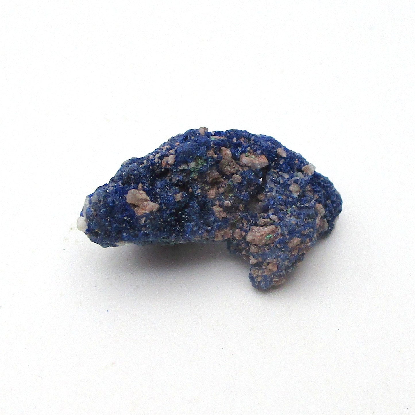 Blue mineral sample on a white background