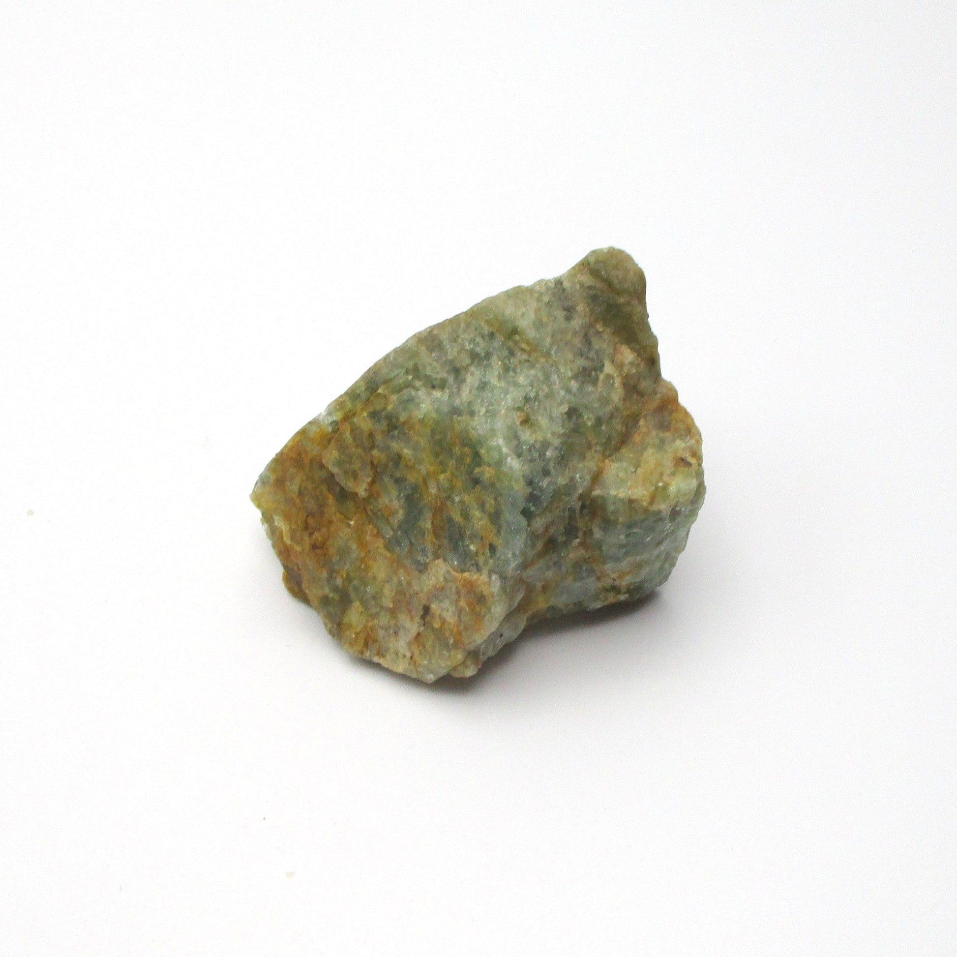 A rough Aquamarine crystal against a white background