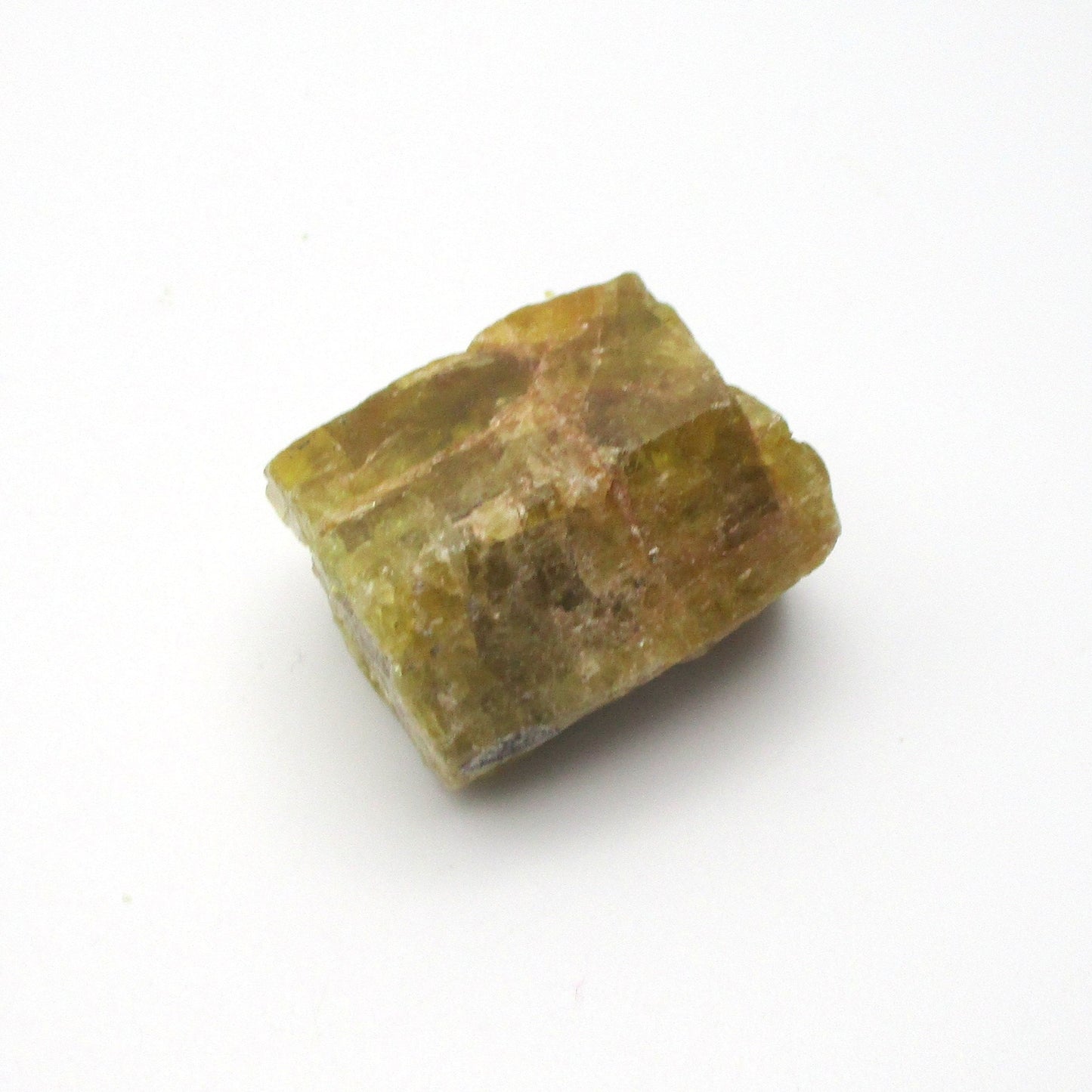 A rough-cut Aquamarine crystal against a white background.
