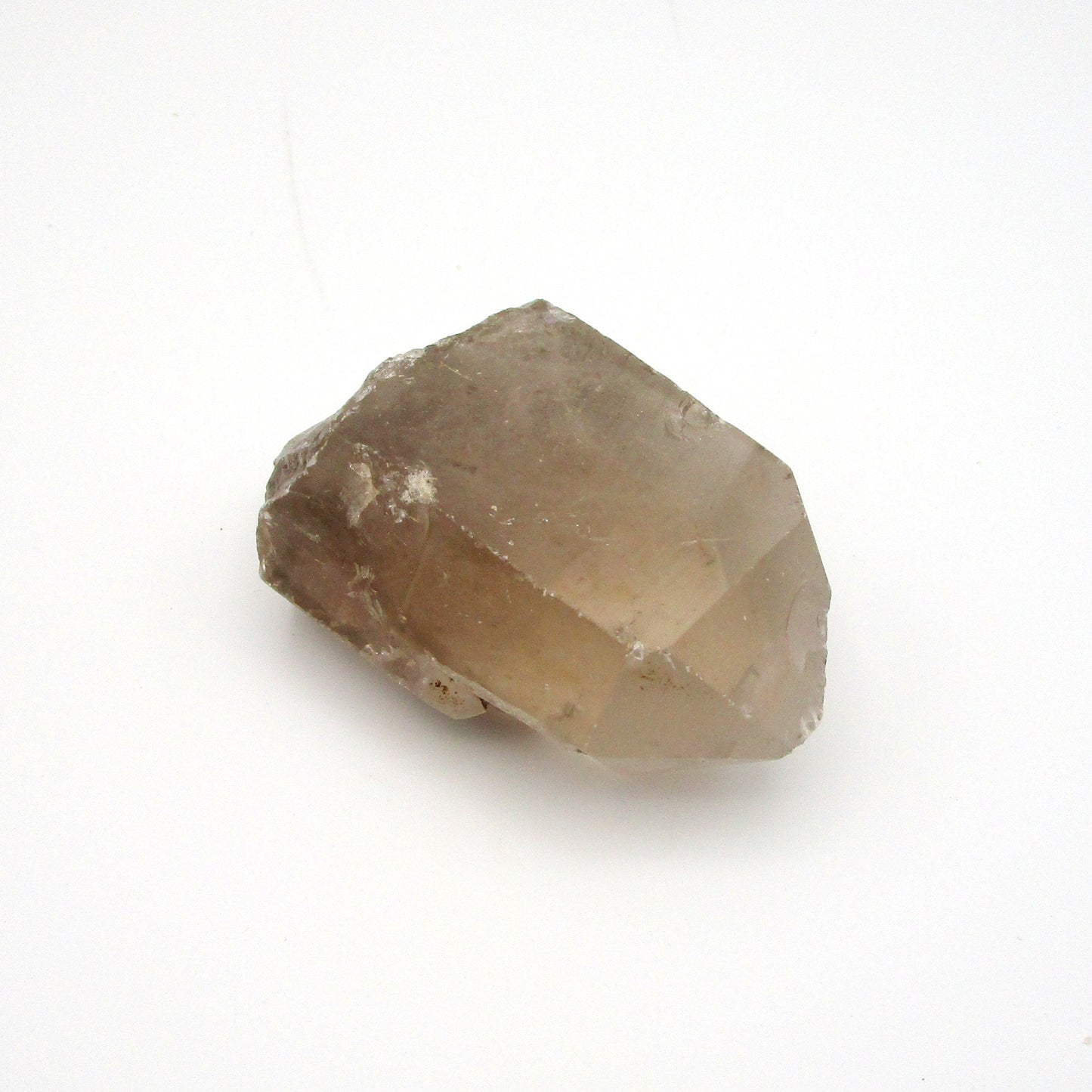 A photograph of a raw Russian Quartz Point with a smoky color.