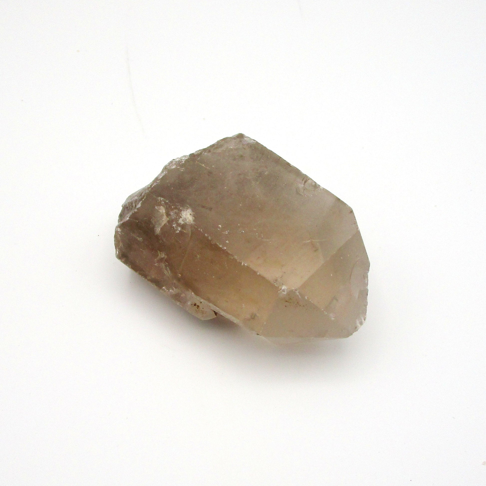 A photograph of a raw Russian Quartz Point with a smoky color.