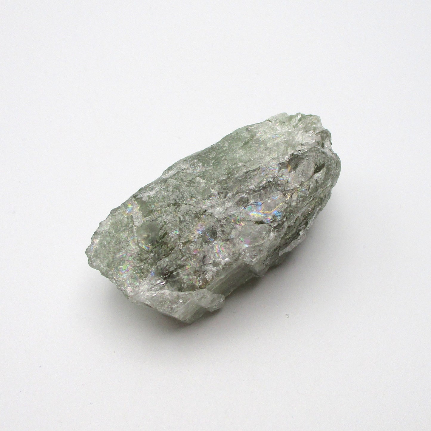 A rough Aquamarine crystal with a greenish tint on a white background.
