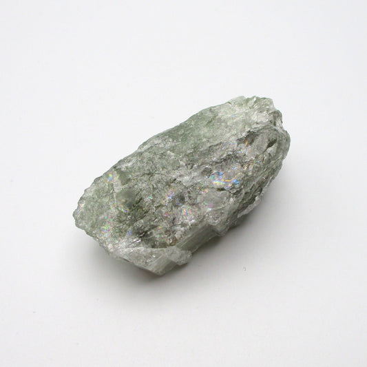 A rough Aquamarine crystal with a greenish tint on a white background.