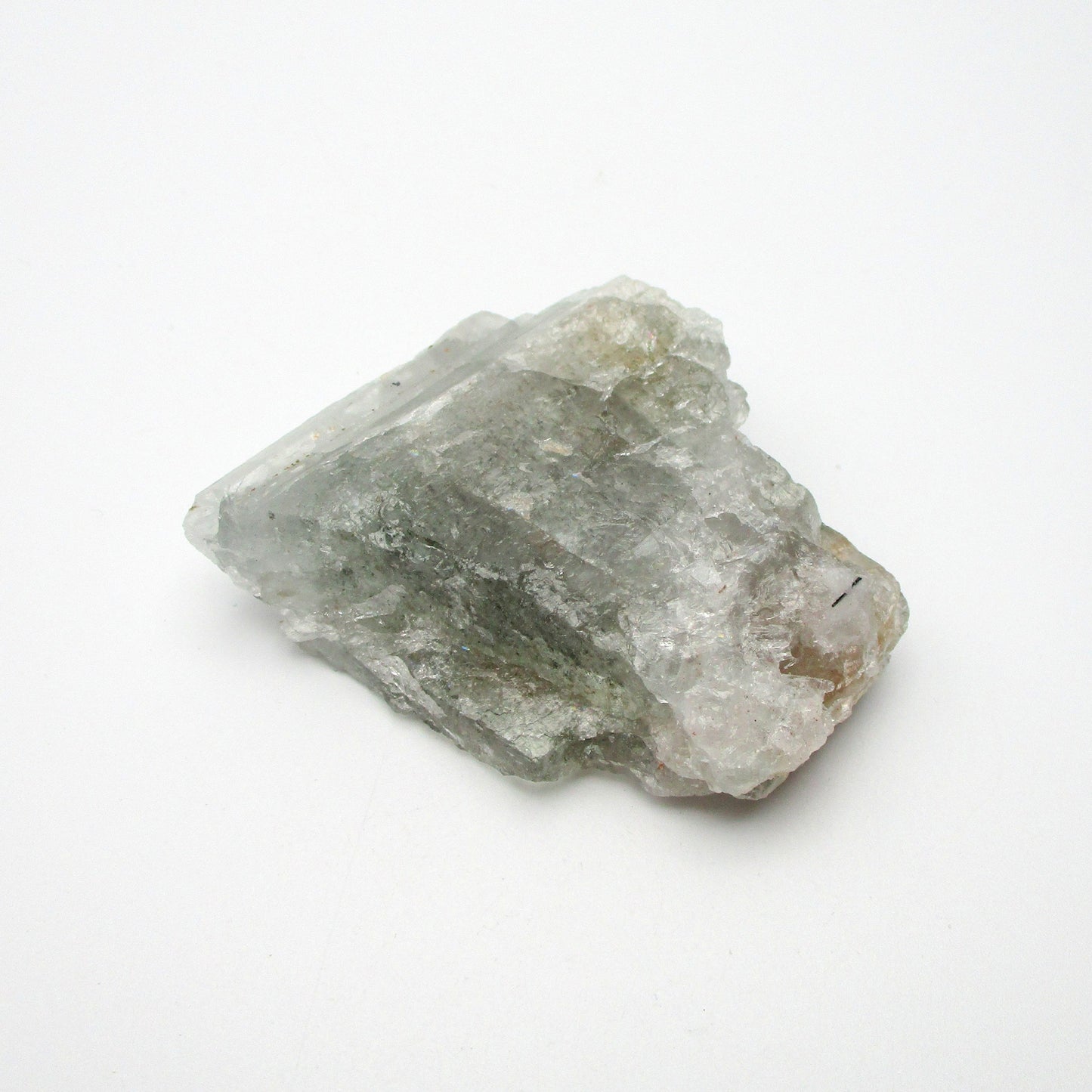 A rough Aquamarine crystal with a translucent greenish appearance, displayed on a white background.