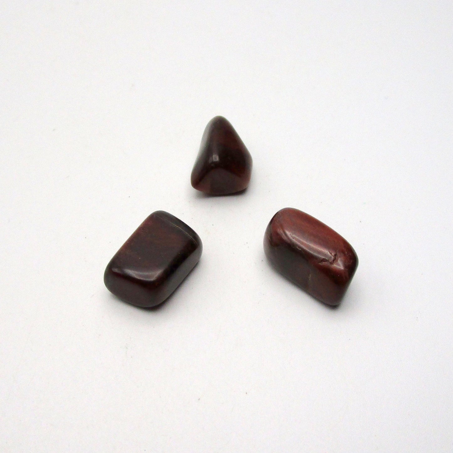 Set of three red tigers eye on white background