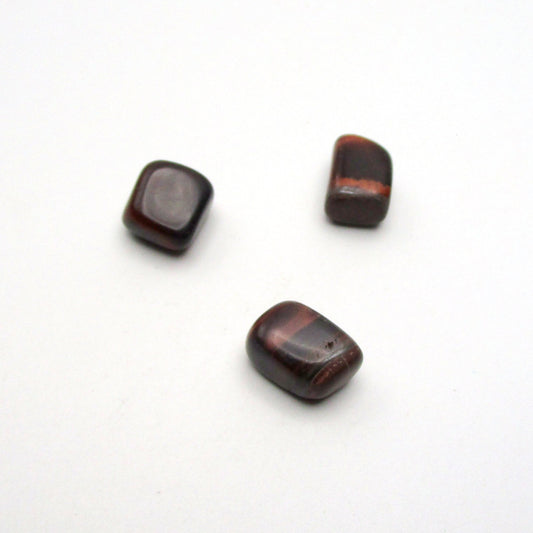 Set of three tumbled red tigers eye on white background