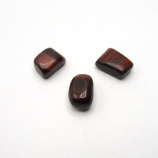 Set of three tumbled red tigers eye on white background