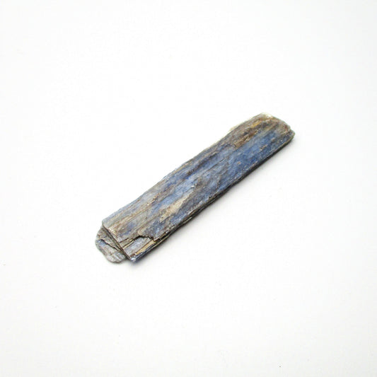 A raw Brazilian blue kyanite crystal displayed on a white background