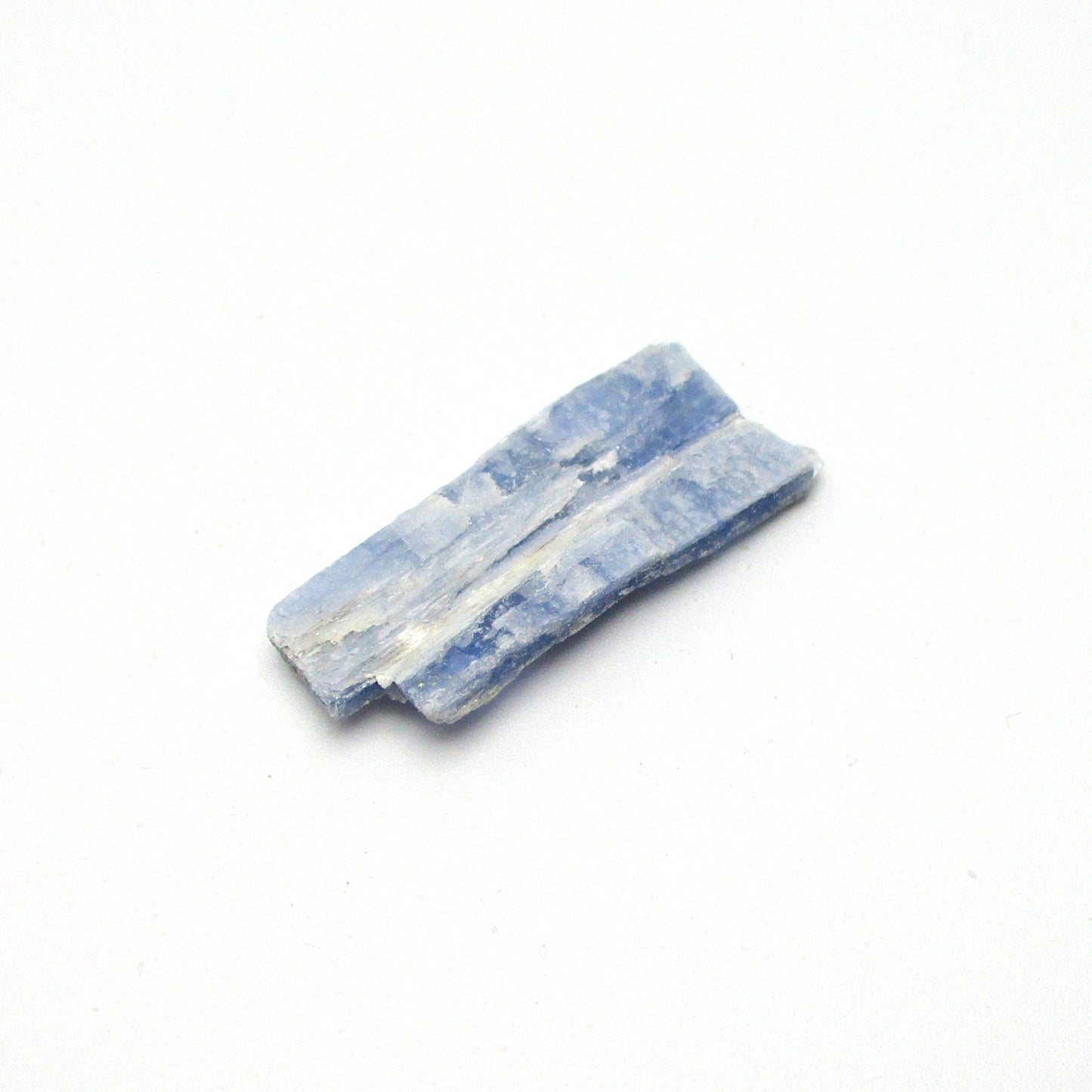 A small piece of Brazilian blue kyanite crystal, displayed on a white background.