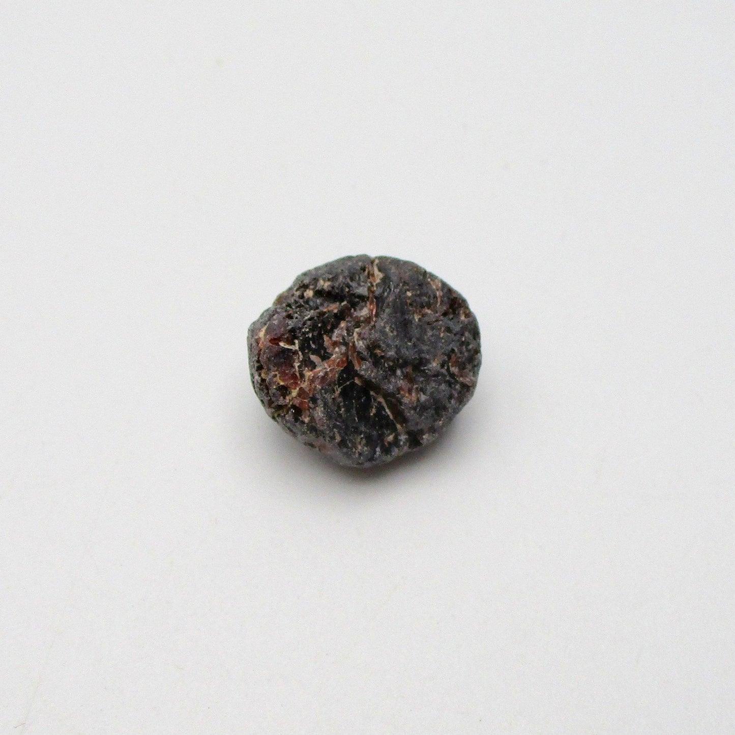 Almandine garnet on a white background
