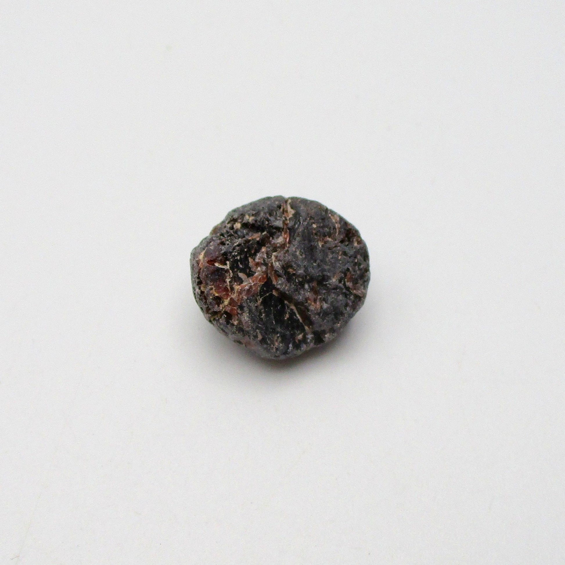 Almandine garnet on a white background