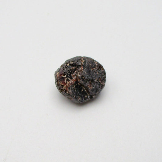 Almandine garnet on a white background