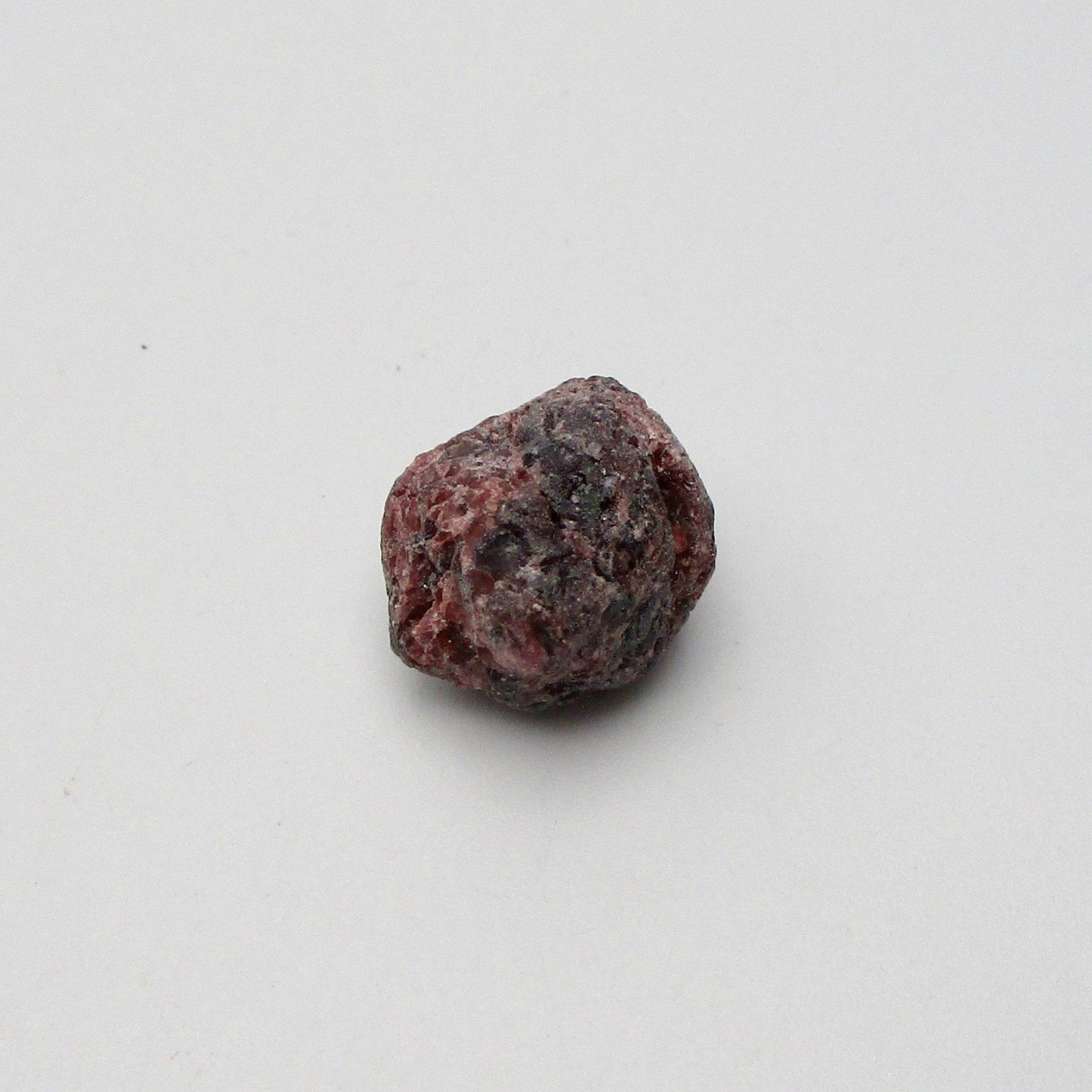 Almandine garnet on a white background