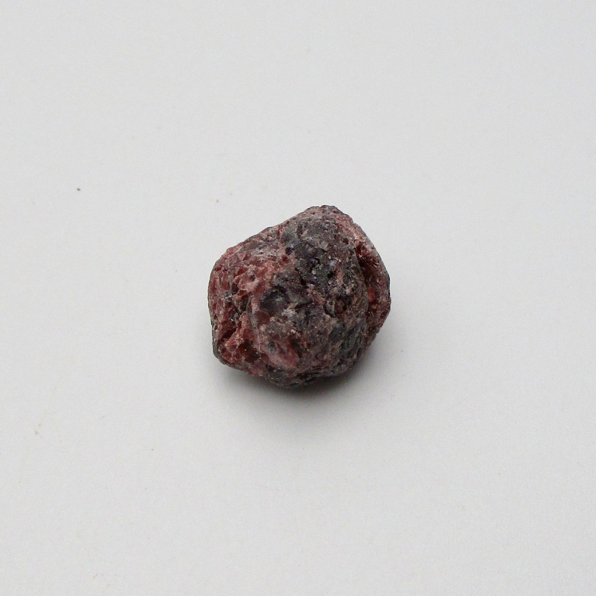Almandine garnet on a white background