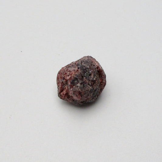 Almandine garnet on a white background
