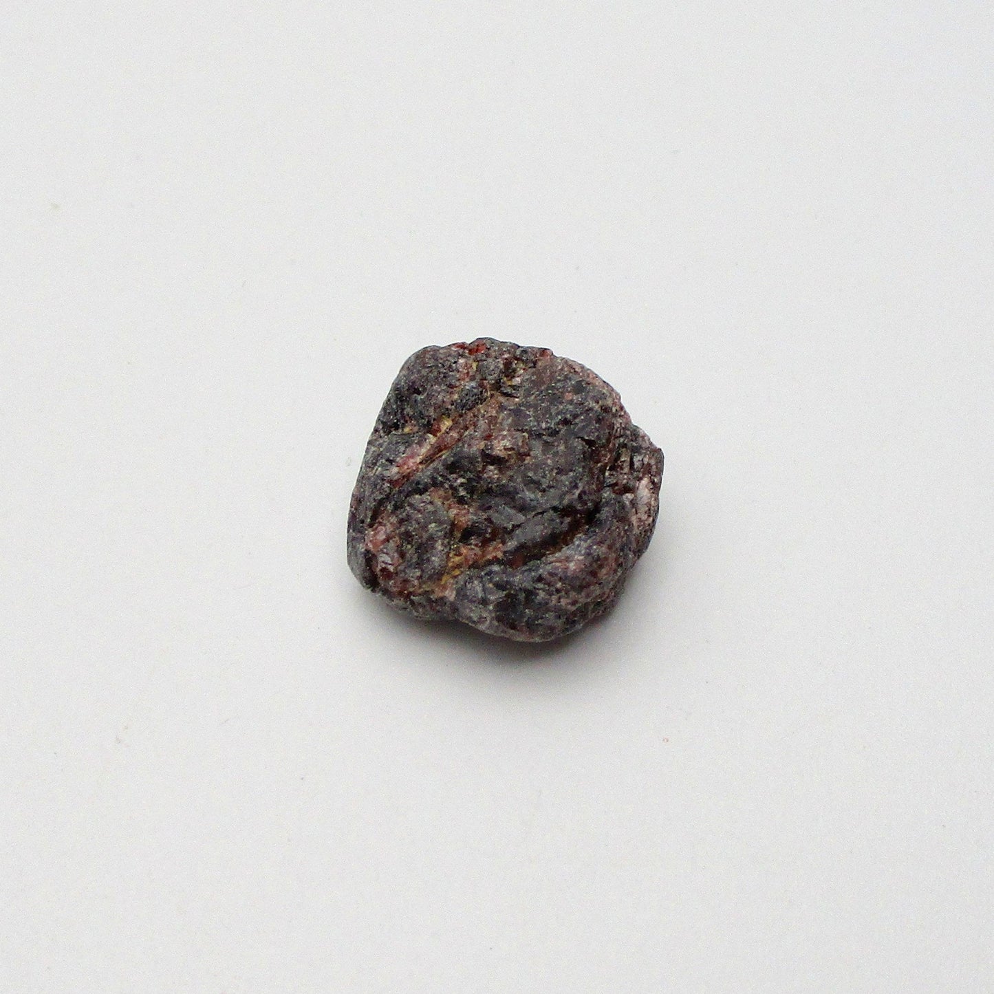 Almandine garnet on a white background