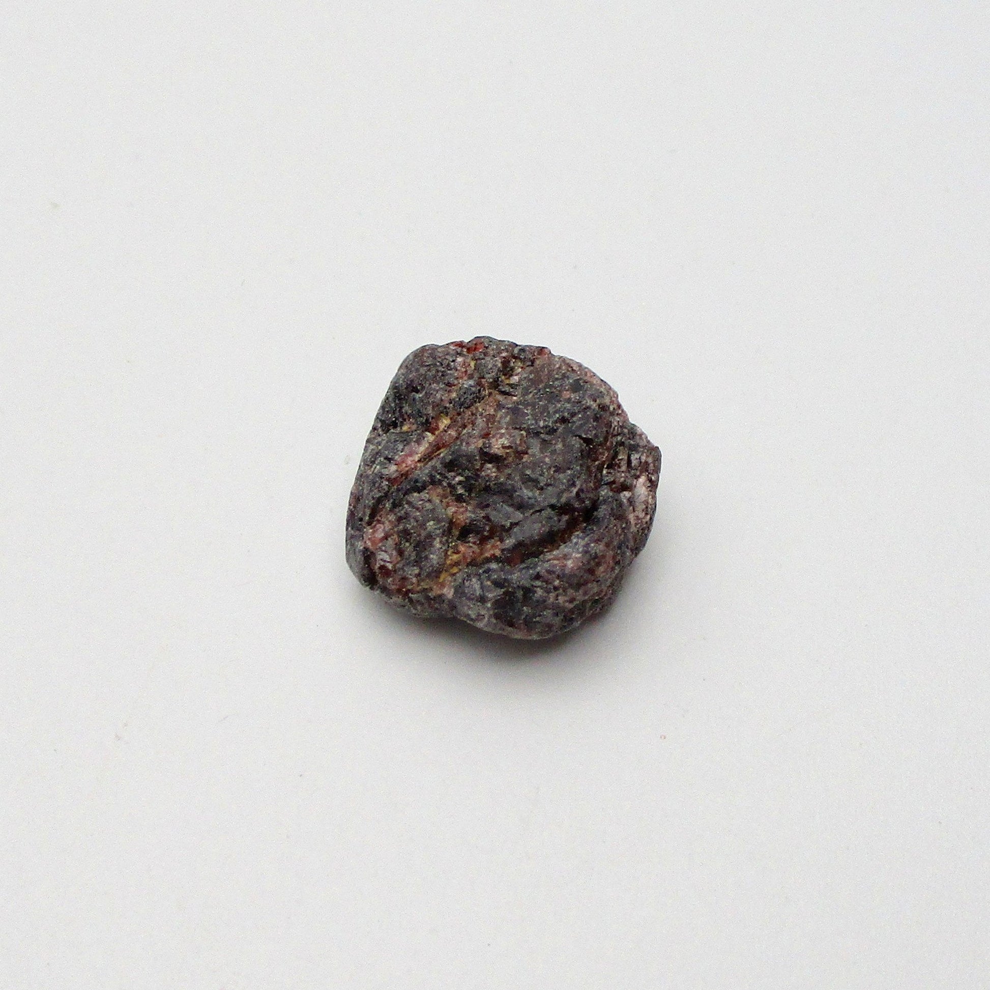 Almandine garnet on a white background