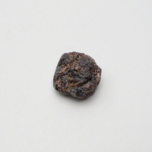 Almandine garnet on a white background