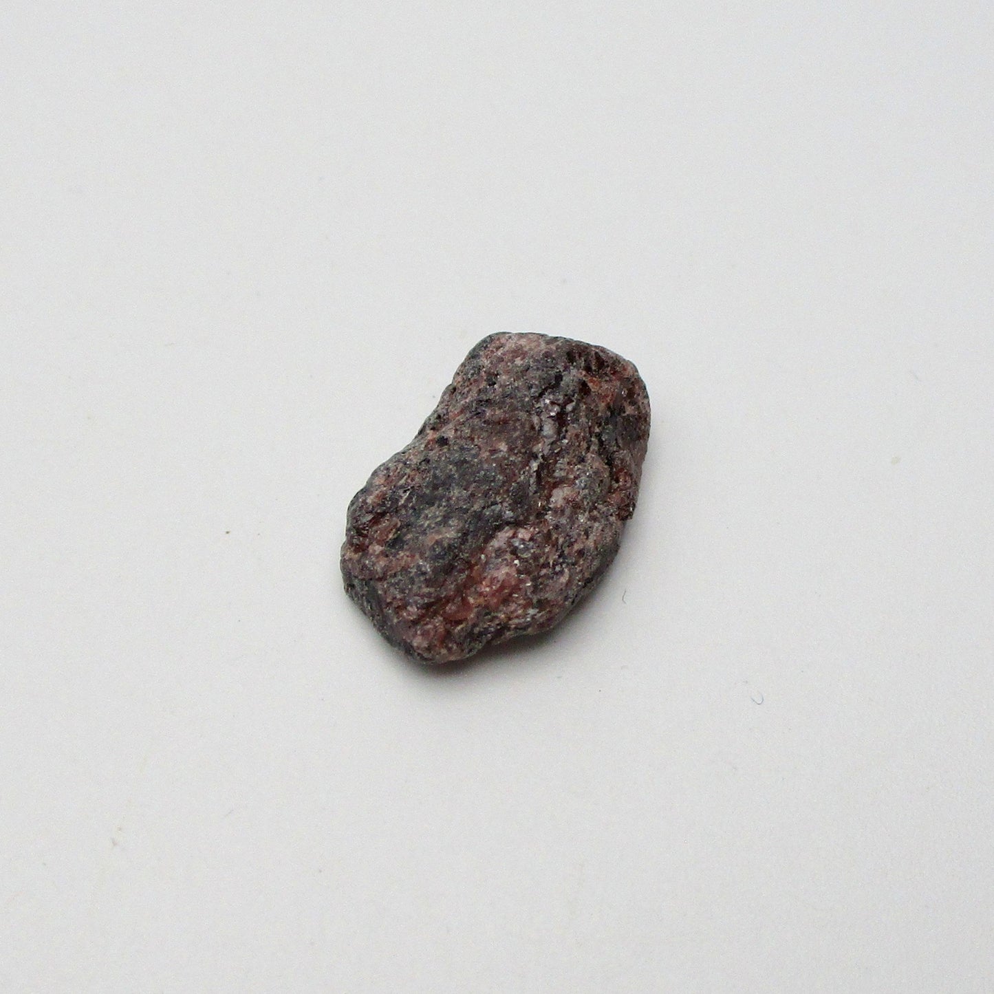 Almandine garnet on a white background