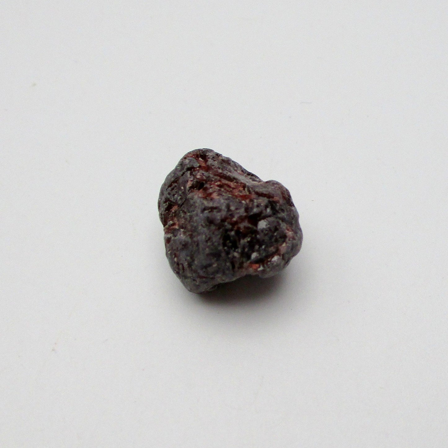 Almandine garnet on a white background