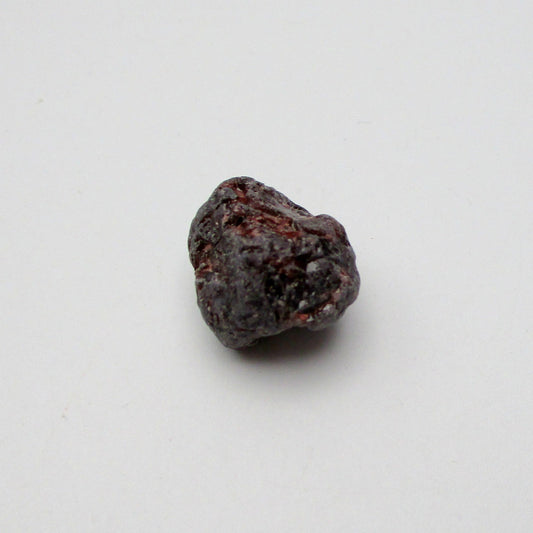 Almandine garnet on a white background