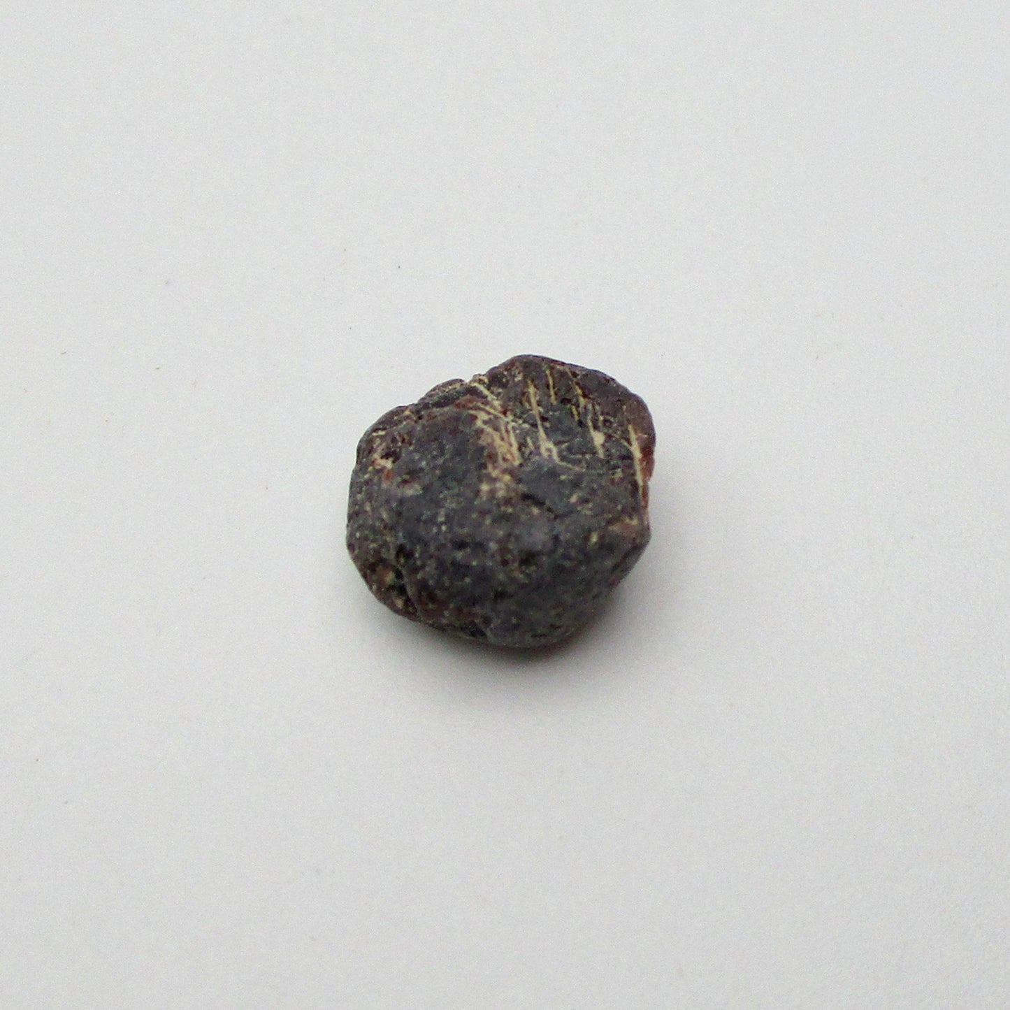 Almandine garnet on a white background