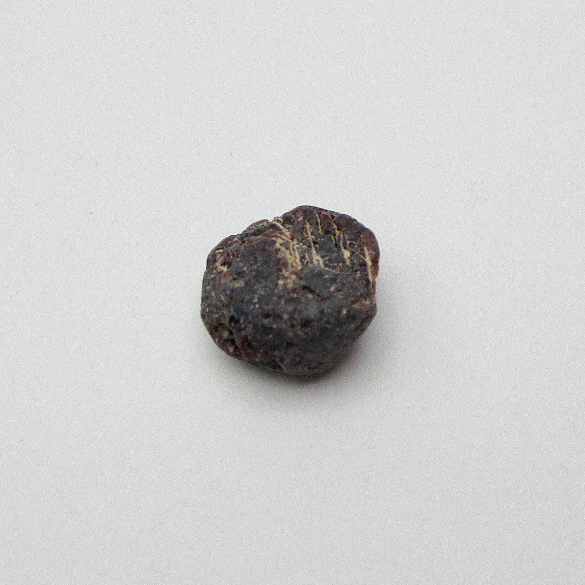 Almandine garnet on a white background