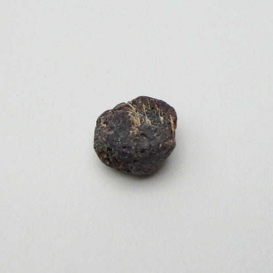 Almandine garnet on a white background