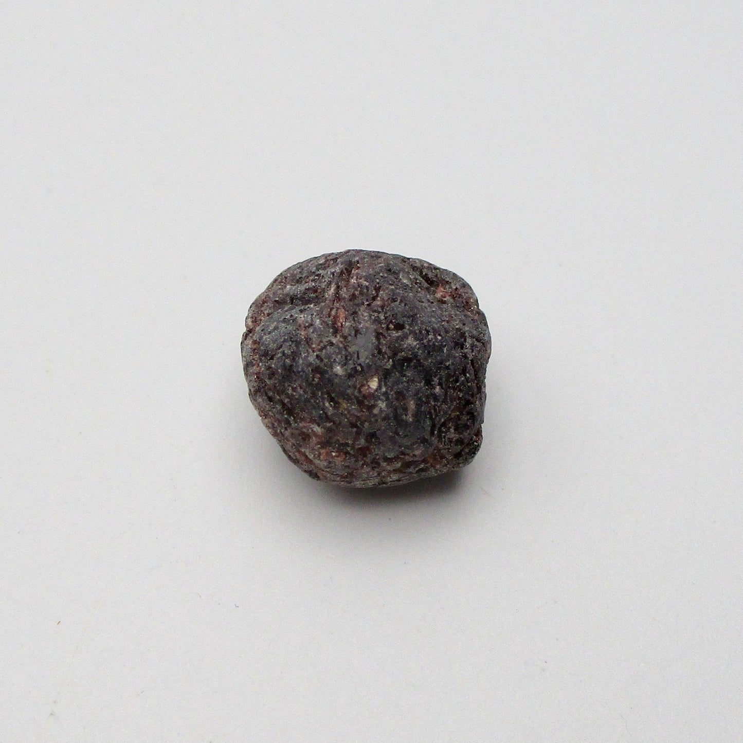 Almandine garnet on a white background