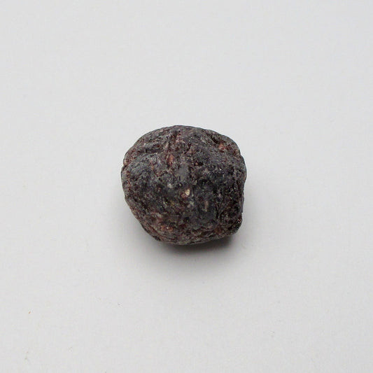 Almandine garnet on a white background