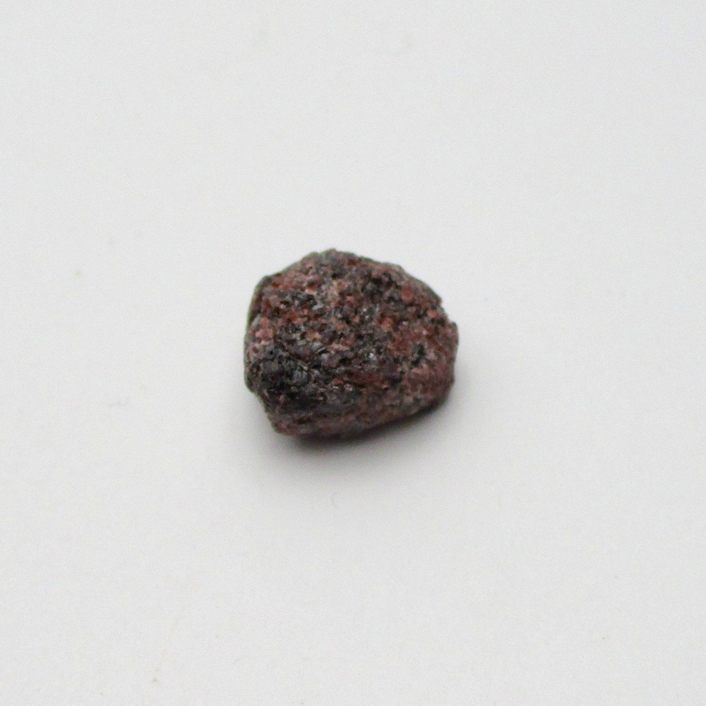 Almandine garnet on a white background