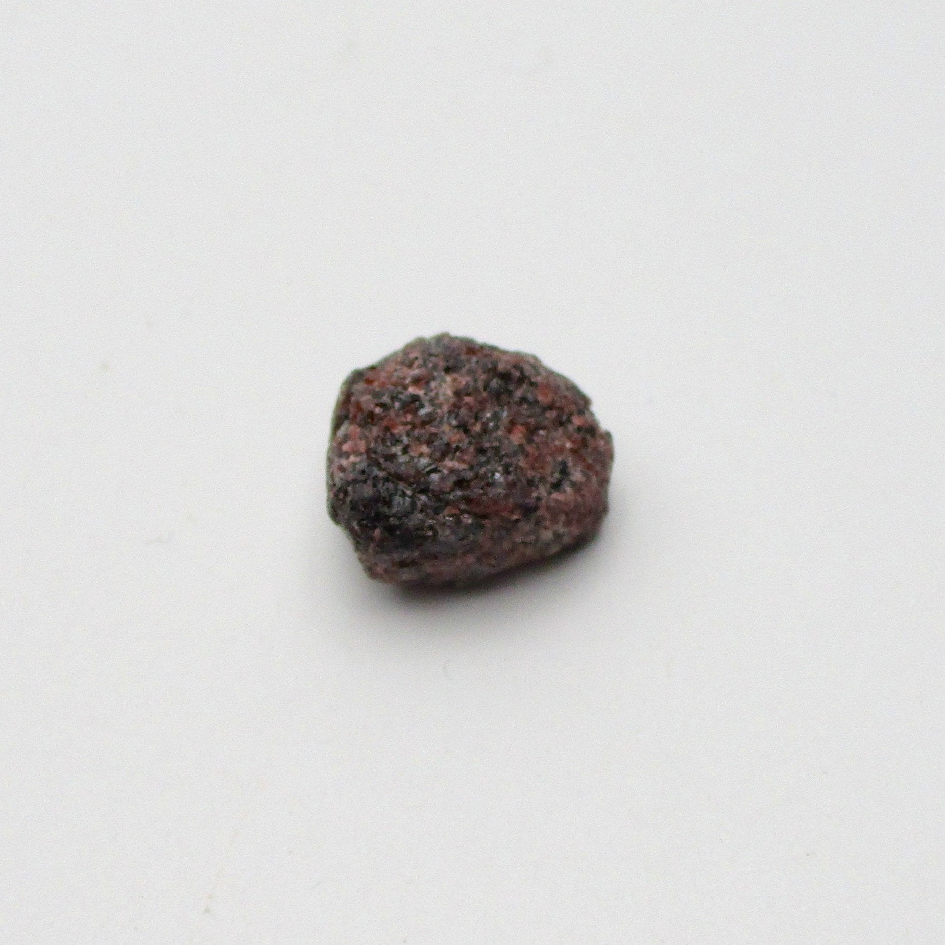 Almandine garnet on a white background