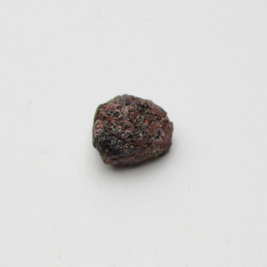 Almandine garnet on a white background