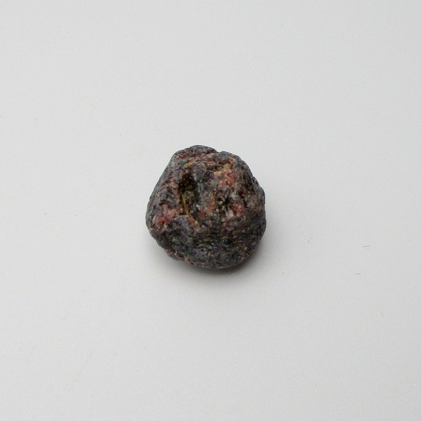 Almandine garnet on a white background