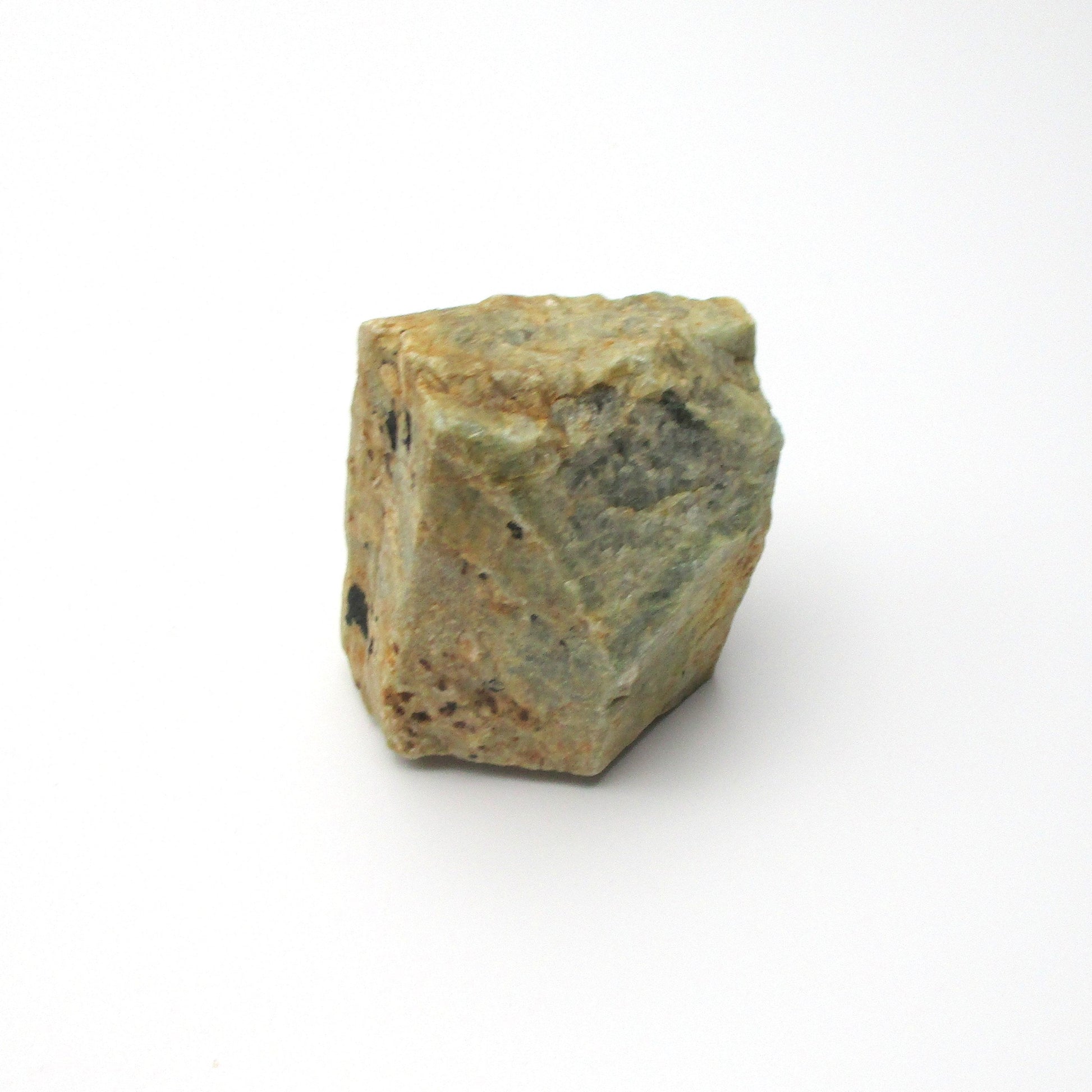A rough Aquamarine crystal against a white background