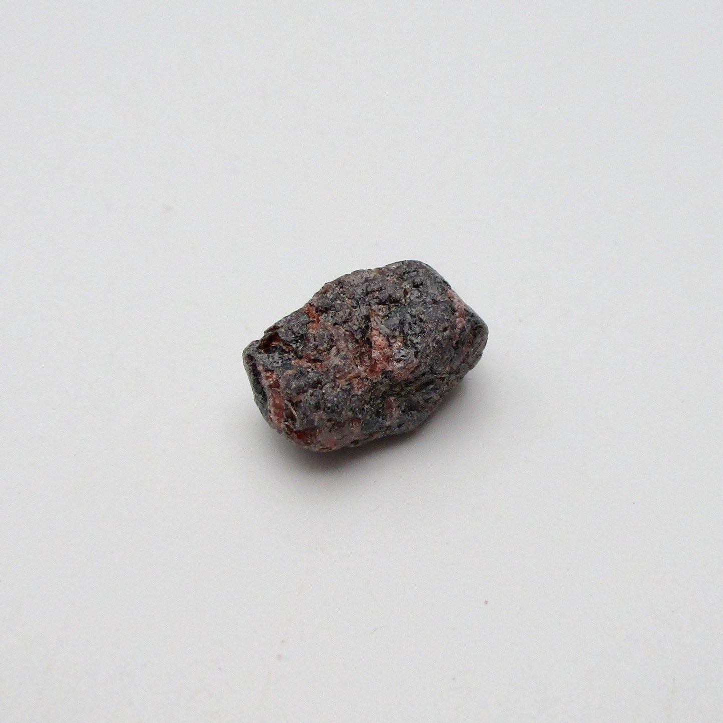 Almandine garnet on a white background
