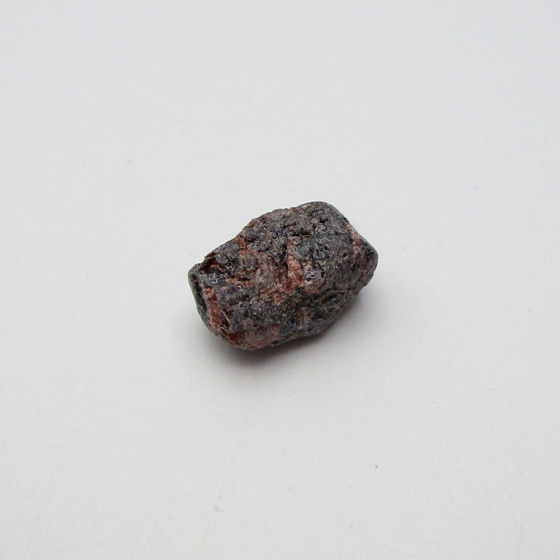 Almandine garnet on a white background