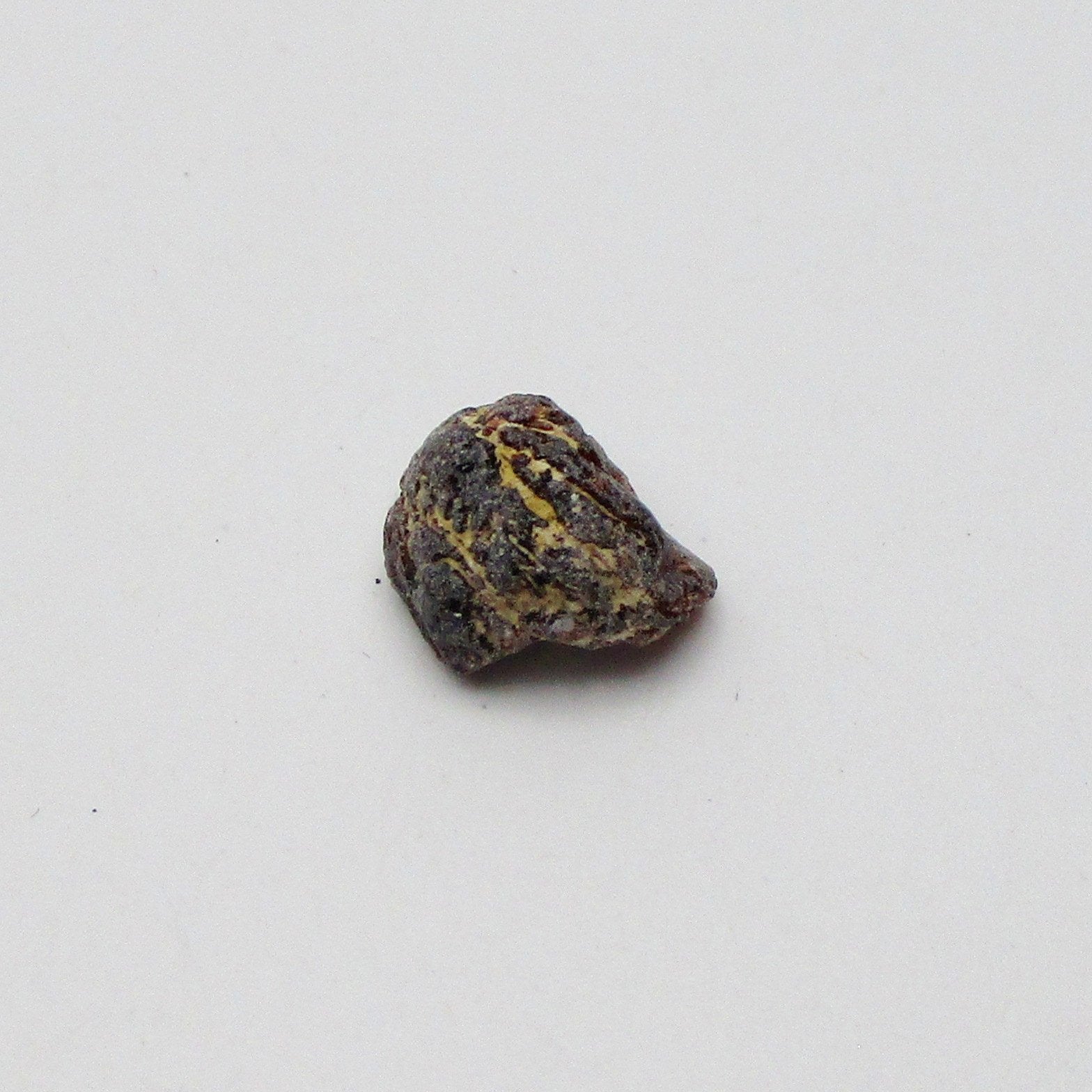 Almandine garnet on a white background