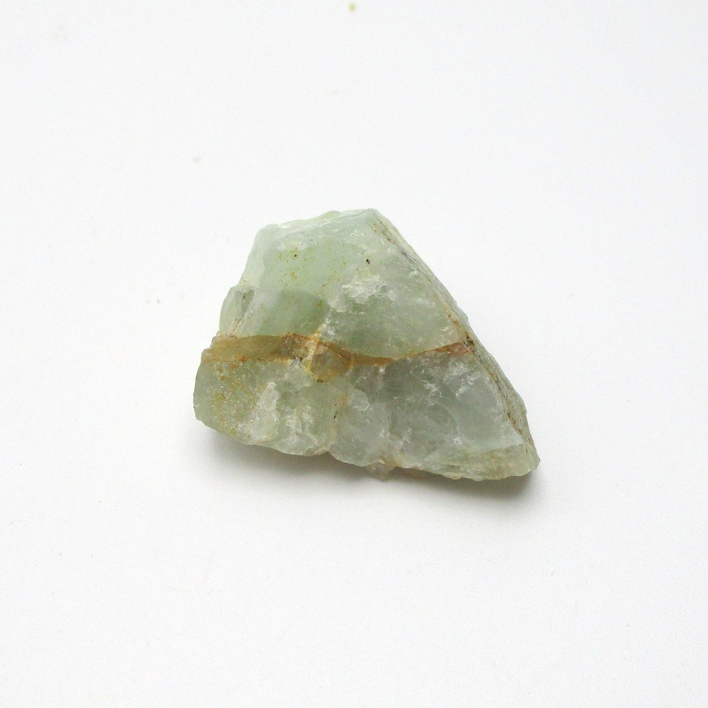 A rough-cut Aquamarine gemstone with a pale blue color and inclusion lines, displayed on a white background.