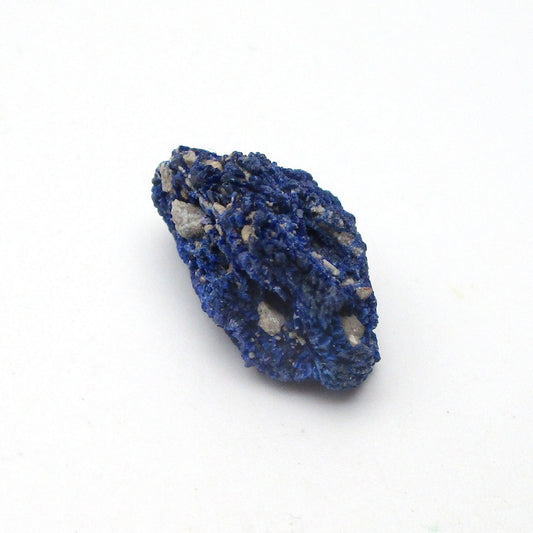 Blue mineral sample on a white background