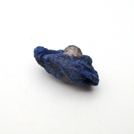 Blue mineral sample on a white background