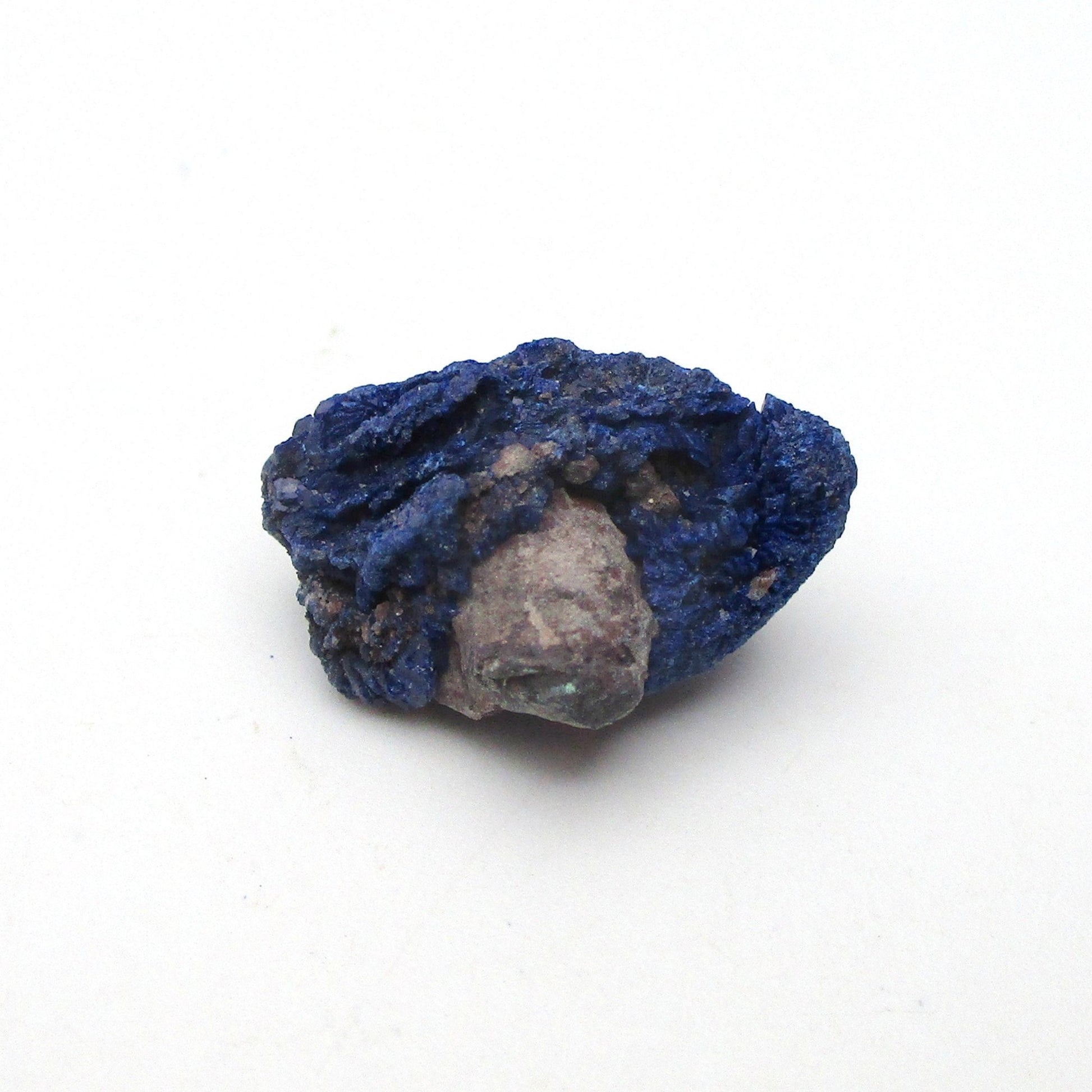 small blue azurite crystal on a white background