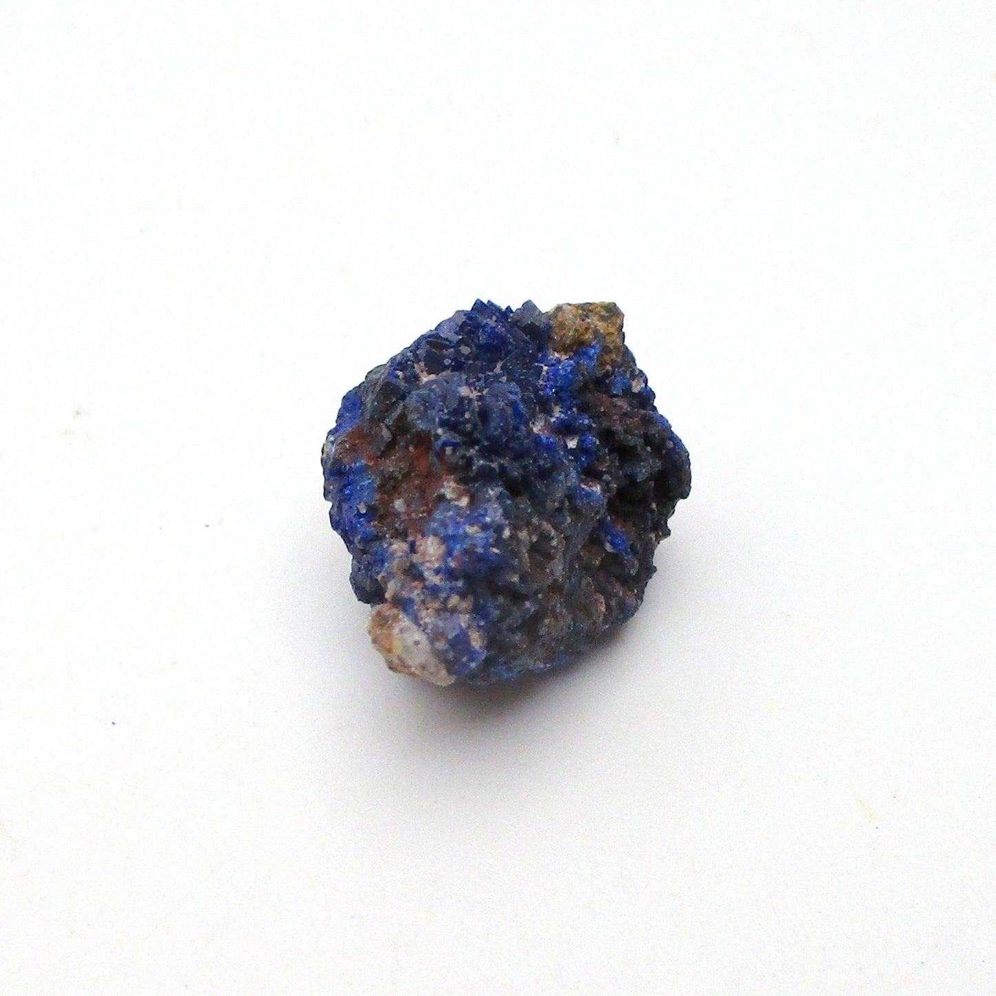 small blue azurite crystal on a white background