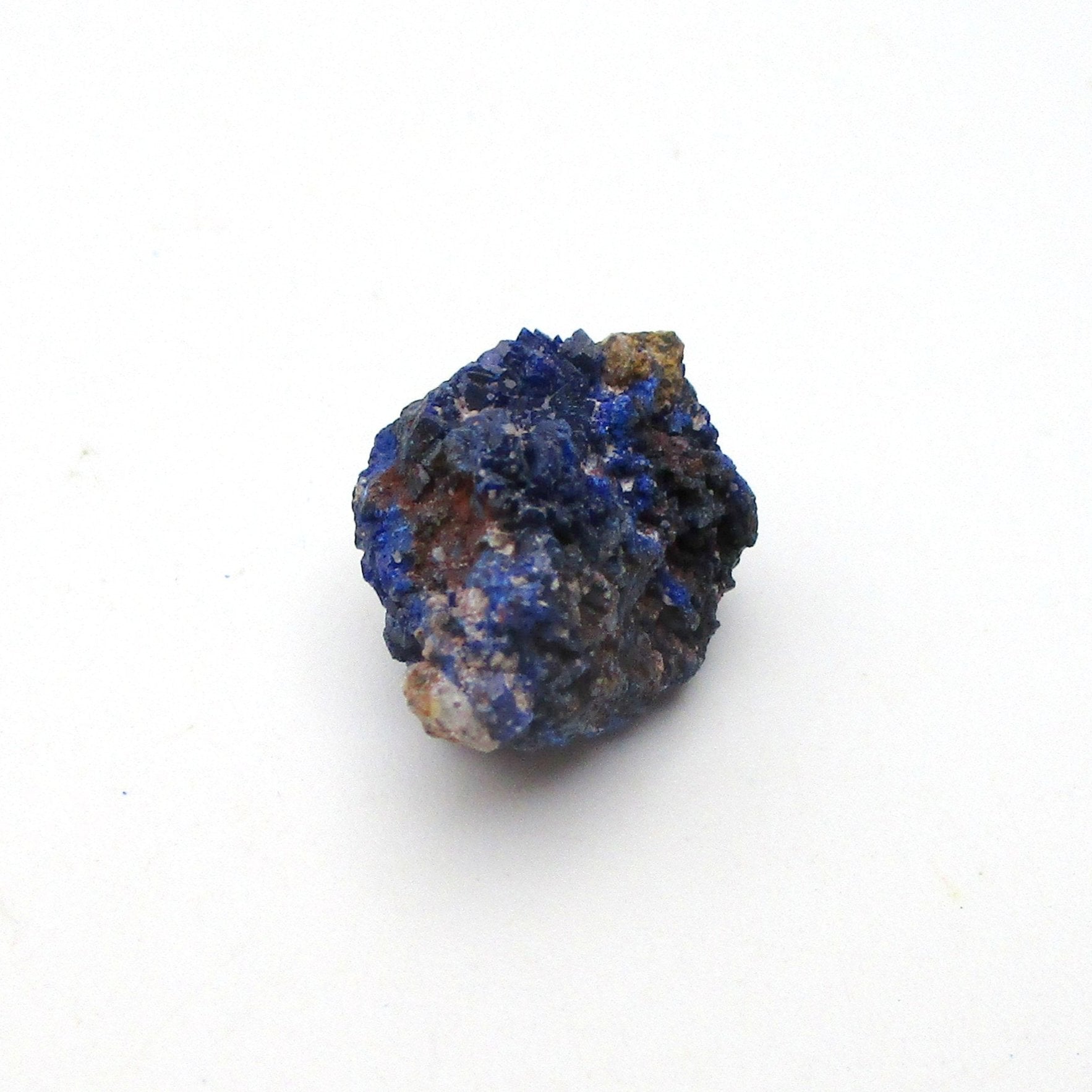 small blue azurite crystal on a white background