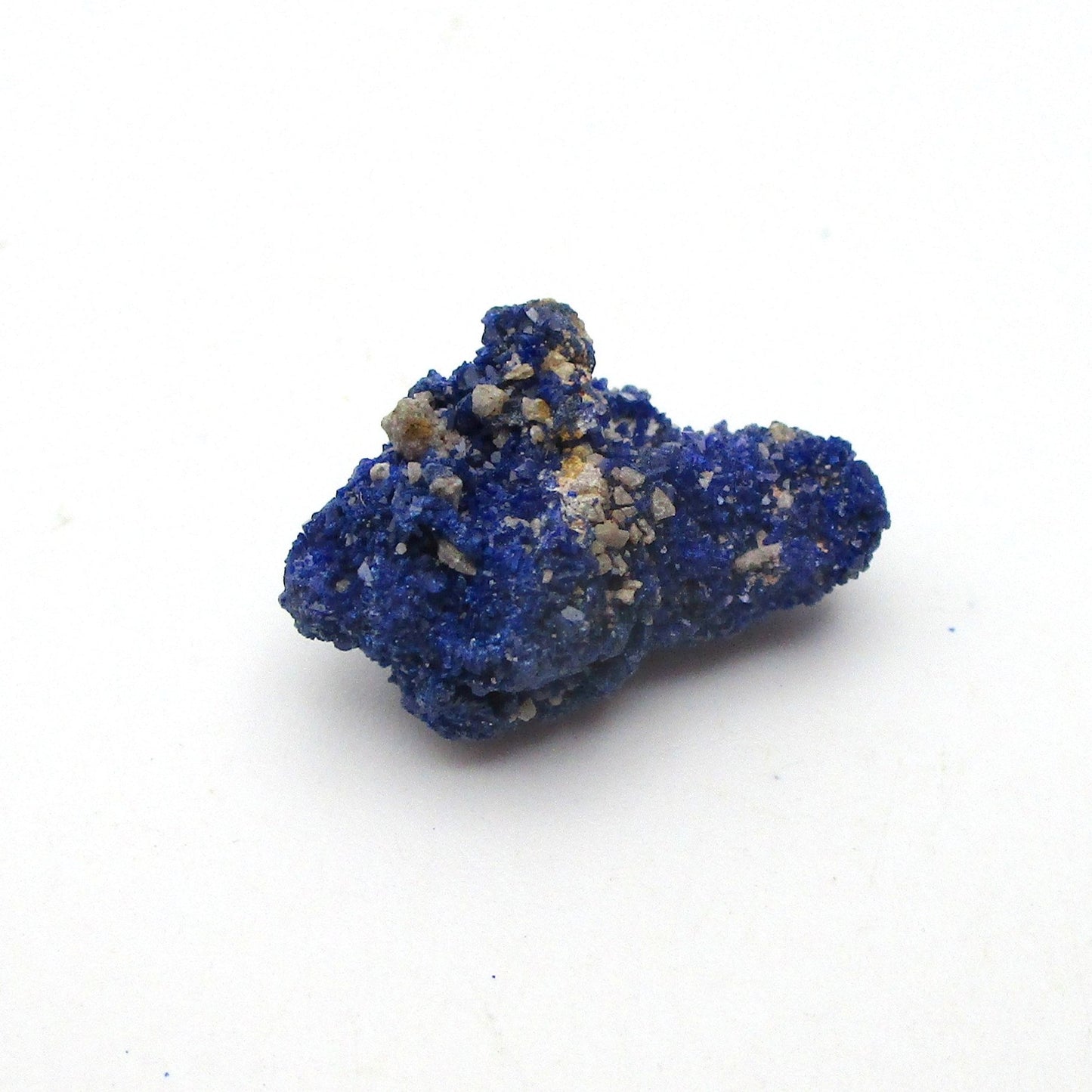 small blue azurite crystal on a white background