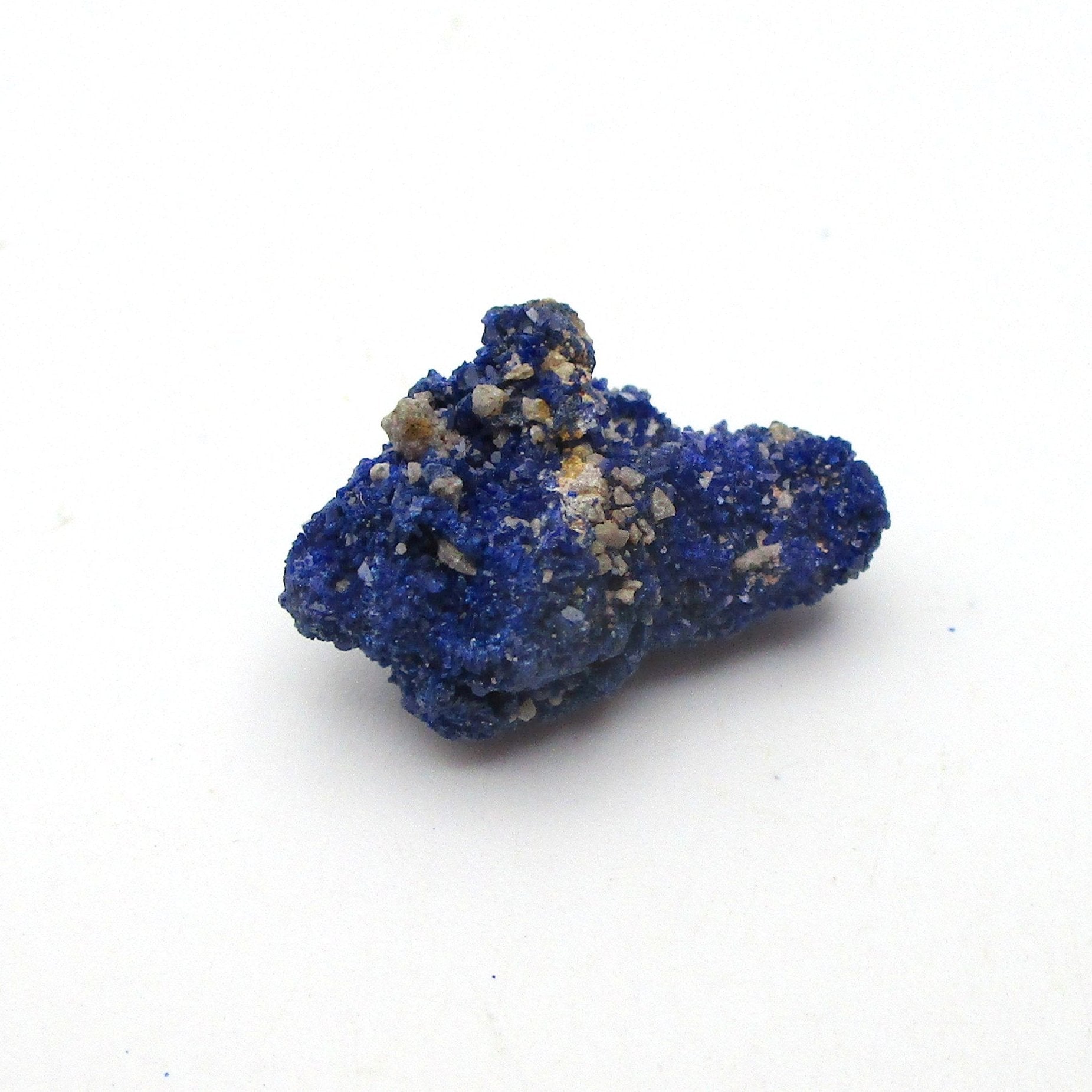 small blue azurite crystal on a white background