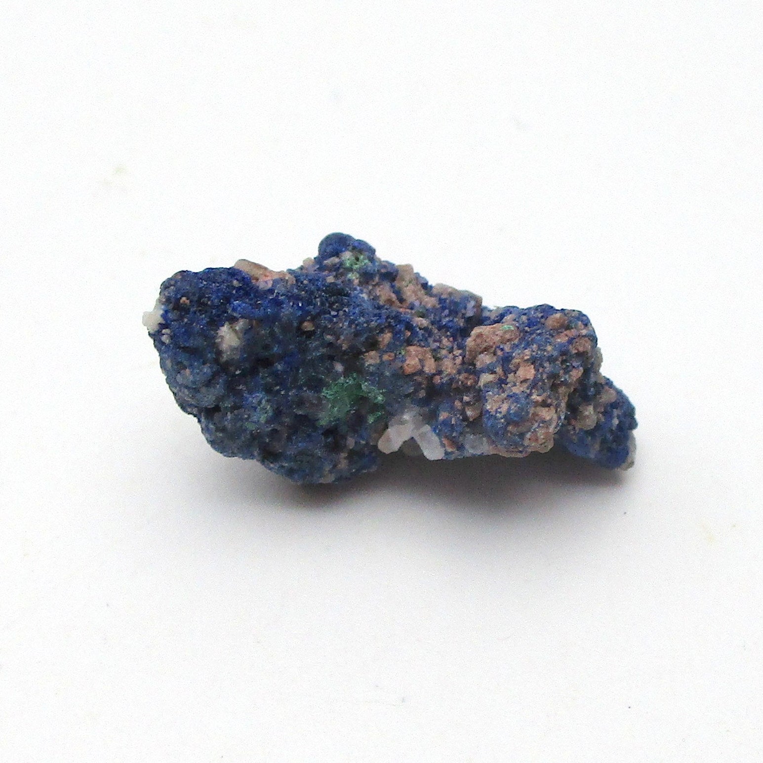small blue azurite crystal on a white background
