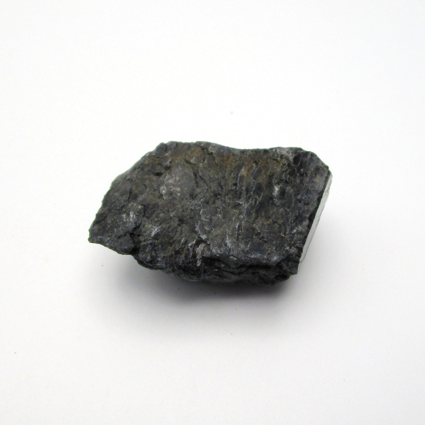A rough, black tourmaline crystal with a metallic sheen, approximately 1 inch in size, displayed on a white background.