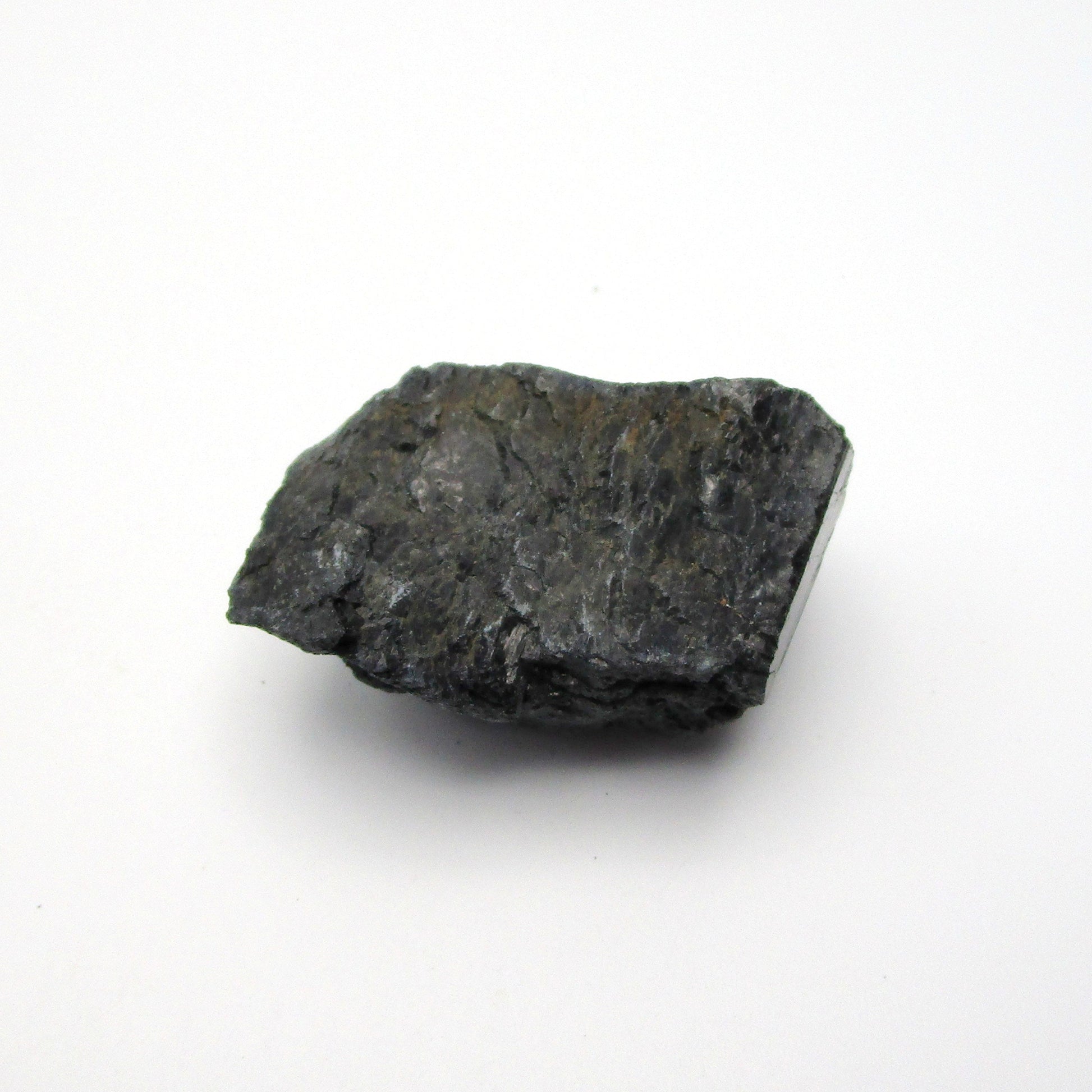 A rough, black tourmaline crystal with a metallic sheen, approximately 1 inch in size, displayed on a white background.