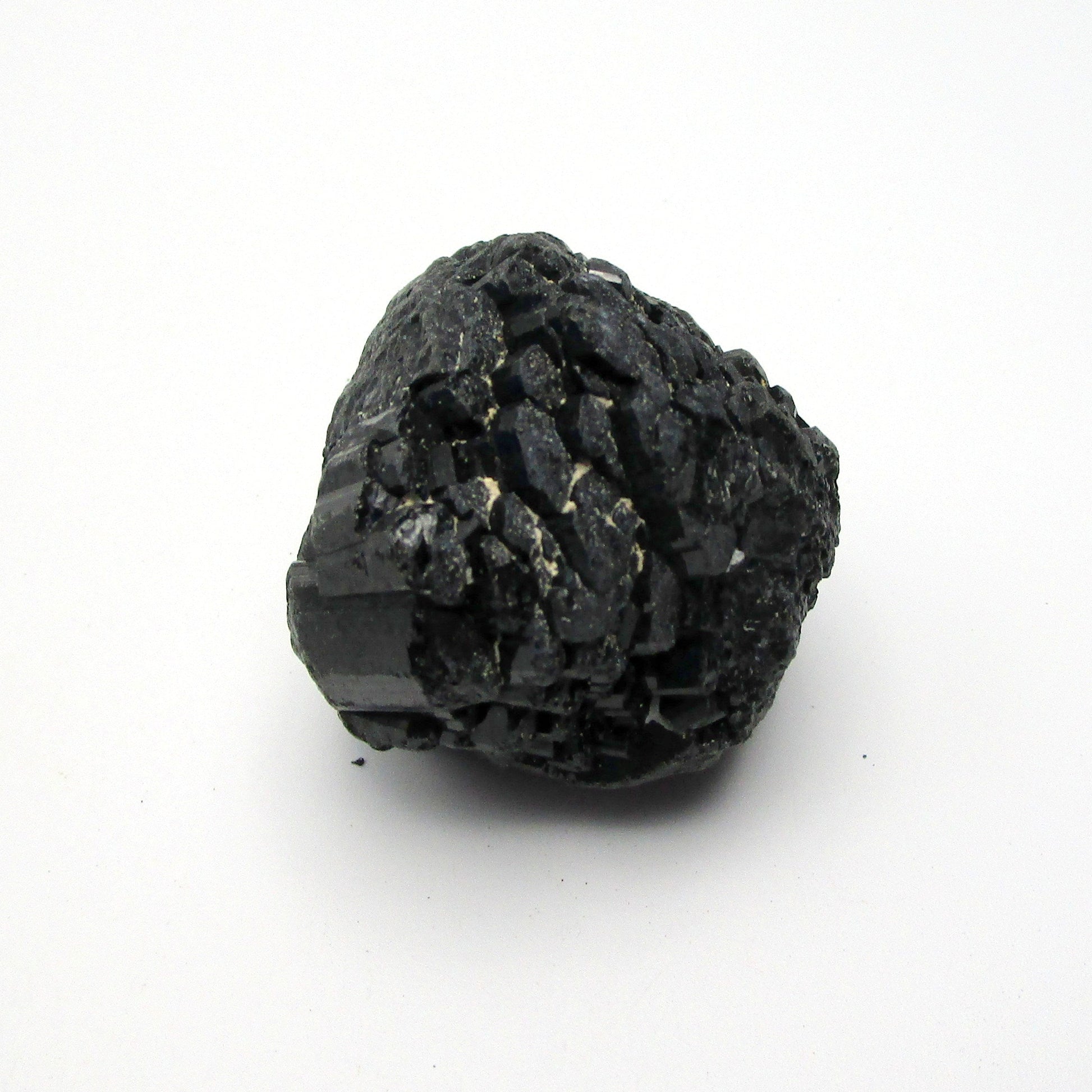 A rough, black tourmaline crystal with a metallic sheen, approximately 1 inch in size, displayed on a white background.